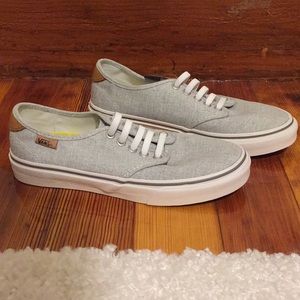 Grey Vans with tan leather details.